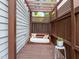 Cozy backyard swing with decorative pillows under a shaded pergola at 7829 Acc Blvd, Raleigh, NC 27617