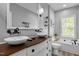 Bathroom featuring double sinks, a jacuzzi tub, and decorative fixtures and finishes at 7829 Acc Blvd, Raleigh, NC 27617