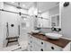 Modern bathroom with white subway tile, glass-enclosed shower, and dual vessel sinks at 7829 Acc Blvd, Raleigh, NC 27617