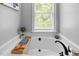 Bright bathroom featuring a white tub with modern faucet and a window offering natural light at 7829 Acc Blvd, Raleigh, NC 27617