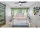 Comfortable bedroom with decorative headboard, soft bedding, and a unique sliding barn door at 7829 Acc Blvd, Raleigh, NC 27617