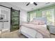 Bedroom with an accent wall, with plush bedding, and a decorative sliding barn door at 7829 Acc Blvd, Raleigh, NC 27617