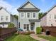 Inviting home with a charming front patio and landscaped lawn, ideal for relaxing outdoors at 7829 Acc Blvd, Raleigh, NC 27617