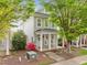 Inviting two-story home with a cozy front porch, rocking chairs, and vibrant landscaping at 7829 Acc Blvd, Raleigh, NC 27617