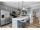 Stylish kitchen featuring gray cabinets, a center island, and stainless steel appliances at 7829 Acc Blvd, Raleigh, NC 27617