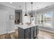 Open kitchen with gray cabinets, white countertops, and island with pendant lighting at 7829 Acc Blvd, Raleigh, NC 27617