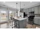Modern kitchen featuring a center island with pendant lighting and stainless steel appliances at 7829 Acc Blvd, Raleigh, NC 27617