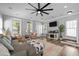 Comfortable living room featuring a ceiling fan, fireplace, and ample seating at 7829 Acc Blvd, Raleigh, NC 27617