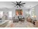 Cozy living room with large ceiling fan, colorful rug, and gray sofa with decorative pillows at 7829 Acc Blvd, Raleigh, NC 27617