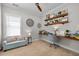 Office space featuring a built-in desk, comfortable seating, and shelving for storage and decor at 7829 Acc Blvd, Raleigh, NC 27617