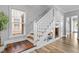 Stylish staircase with white railings and wooden steps, complemented by a built-in bookshelf at 7829 Acc Blvd, Raleigh, NC 27617
