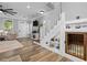 Open-concept staircase with a cozy pet nook underneath and views into the living room at 7829 Acc Blvd, Raleigh, NC 27617