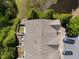 An aerial view shows the roof, a pond, and the back area with fencing and trees at 7851 Allscott Way, Raleigh, NC 27612