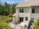 View of the townhome's backyard with a small patio and privacy fence at 7851 Allscott Way, Raleigh, NC 27612