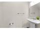 Clean bathroom featuring a pedestal sink and modern fixtures at 7851 Allscott Way, Raleigh, NC 27612