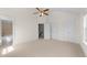 Well-lit bedroom with neutral carpet, ceiling fan, and convenient access to bathroom and closets at 7851 Allscott Way, Raleigh, NC 27612