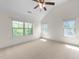 Spacious bedroom featuring large windows offering lots of natural light and a ceiling fan at 7851 Allscott Way, Raleigh, NC 27612