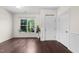 Bright entryway with dark wood floors, white trim, and natural light from a large window at 7851 Allscott Way, Raleigh, NC 27612