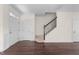 Inviting entryway featuring hardwood floors, staircase, and white trim accents at 7851 Allscott Way, Raleigh, NC 27612