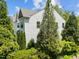 Exterior shot of a beautiful home surrounded by lush greenery and mature trees at 7851 Allscott Way, Raleigh, NC 27612