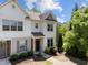 Two-story townhome with light siding, landscaping, and a welcoming front door at 7851 Allscott Way, Raleigh, NC 27612