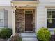 Charming brick entrance to a townhome with lush green and auburn landscaping at 7851 Allscott Way, Raleigh, NC 27612