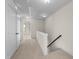 Hallway featuring carpeting, white trim, and access to the upper floor at 7851 Allscott Way, Raleigh, NC 27612