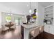 Open kitchen with granite countertops, stainless steel appliances, and an adjacent dining area at 7851 Allscott Way, Raleigh, NC 27612