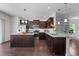 Modern kitchen with granite countertops, stainless steel appliances, and dark wood cabinets at 7851 Allscott Way, Raleigh, NC 27612