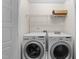 Bright laundry room with front loading LG washer and dryer and wire shelving for storage at 7851 Allscott Way, Raleigh, NC 27612