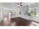 Open concept living room with ceiling fan, built-in bookshelves and hardwood floors at 7851 Allscott Way, Raleigh, NC 27612