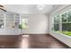 Bright living room featuring dark wood floors, built-in bookshelves, and a large window at 7851 Allscott Way, Raleigh, NC 27612