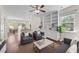Comfortable living room with hardwood floors, ceiling fan and open layout to dining area at 7851 Allscott Way, Raleigh, NC 27612