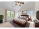 Serene bedroom with high vaulted ceiling, natural light, and a calm, neutral color palette at 7851 Allscott Way, Raleigh, NC 27612