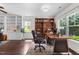 Office space with built-in bookshelves, desk, and natural light from large windows at 7851 Allscott Way, Raleigh, NC 27612