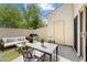 Private patio with modern outdoor furniture, a grill, and a fenced-in backyard at 7851 Allscott Way, Raleigh, NC 27612