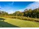 Beautifully maintained backyard with lush green lawn and distant trees creates a park-like feel at 825 Flower Manor Dr, Wendell, NC 27591