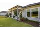 The back of this house has a small, covered porch with an immaculate lawn with lush landscaping at 825 Flower Manor Dr, Wendell, NC 27591
