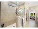 Modern bathroom with walk-in shower, glass partition, and tiled walls at 825 Flower Manor Dr, Wendell, NC 27591