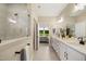 Bathroom featuring a shower and dual sinks, all with views of the bedroom and outside at 825 Flower Manor Dr, Wendell, NC 27591