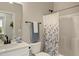 A clean bathroom with a shower and tub combo, plus a sink and toilet with gray wall paint at 825 Flower Manor Dr, Wendell, NC 27591