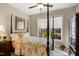 A cozy bedroom featuring a four poster bed, ceiling fan and bright natural light from the window at 825 Flower Manor Dr, Wendell, NC 27591