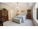 Elegant bedroom with tray ceiling, chandelier, furniture and plenty of natural light at 825 Flower Manor Dr, Wendell, NC 27591