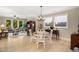 Open concept living space with dining area, wood floors and bright natural light at 825 Flower Manor Dr, Wendell, NC 27591