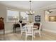 Dining area featuring a modern chandelier, neutral paint and wood laminate flooring at 825 Flower Manor Dr, Wendell, NC 27591