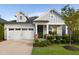 Charming single Gathering home featuring a two-car garage and a welcoming front porch at 825 Flower Manor Dr, Wendell, NC 27591