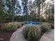 Serene outdoor fire pit area with Adirondack chairs surrounded by lush landscaping at 825 Flower Manor Dr, Wendell, NC 27591