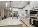 Modern kitchen with stainless steel appliances, large island, white cabinets and beautiful backsplash at 825 Flower Manor Dr, Wendell, NC 27591