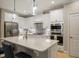 Modern kitchen with white cabinets, stainless steel appliances, and a large center island at 825 Flower Manor Dr, Wendell, NC 27591