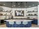 This kitchenette features an island with seating, sink, shelving, and a view of the television at 825 Flower Manor Dr, Wendell, NC 27591